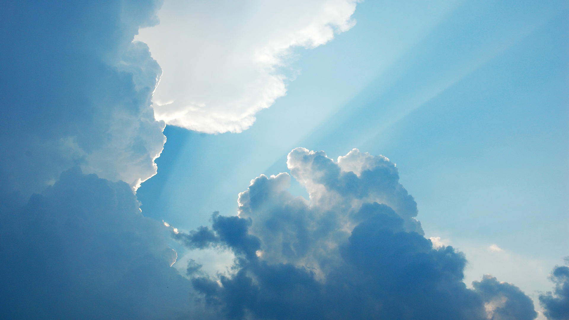 sunbeam radiating from behind the cloud