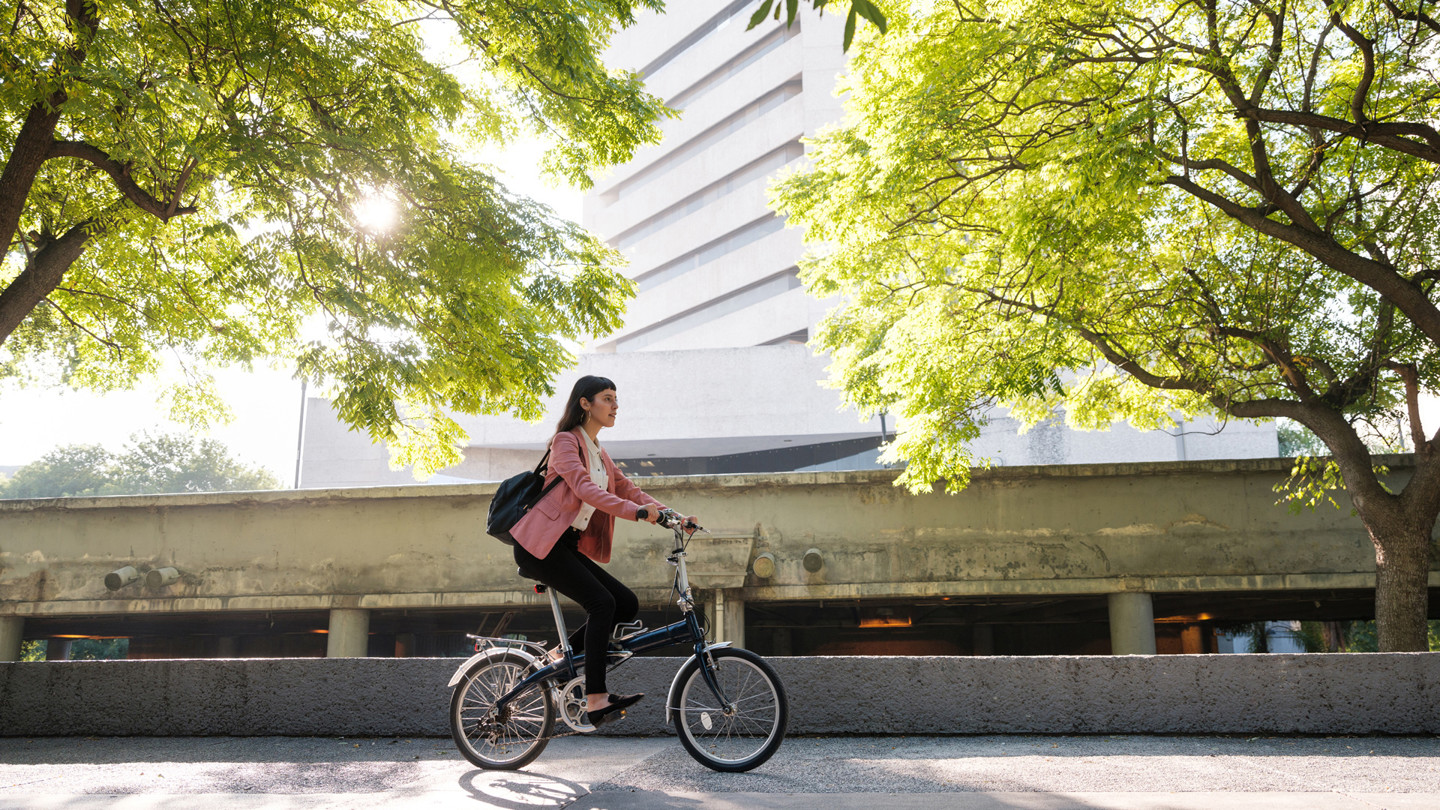 Woman riding a bike along some pavement