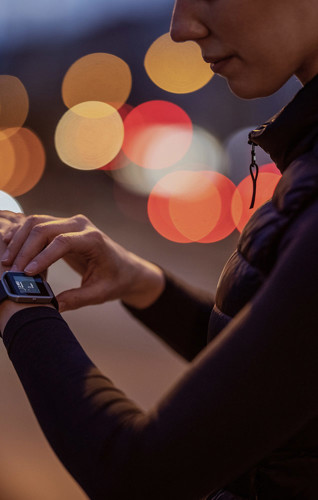Woman looking at smartwatch on her wrist